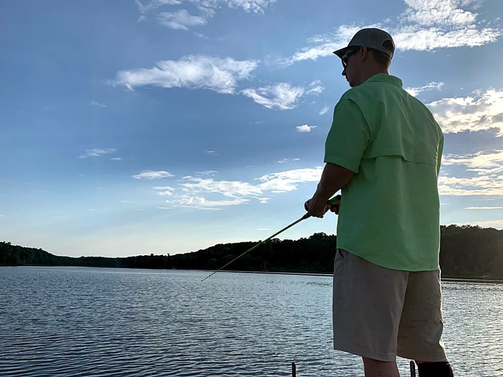 Bradley Griffin casting from a boat on a Michigan lake at dusk
