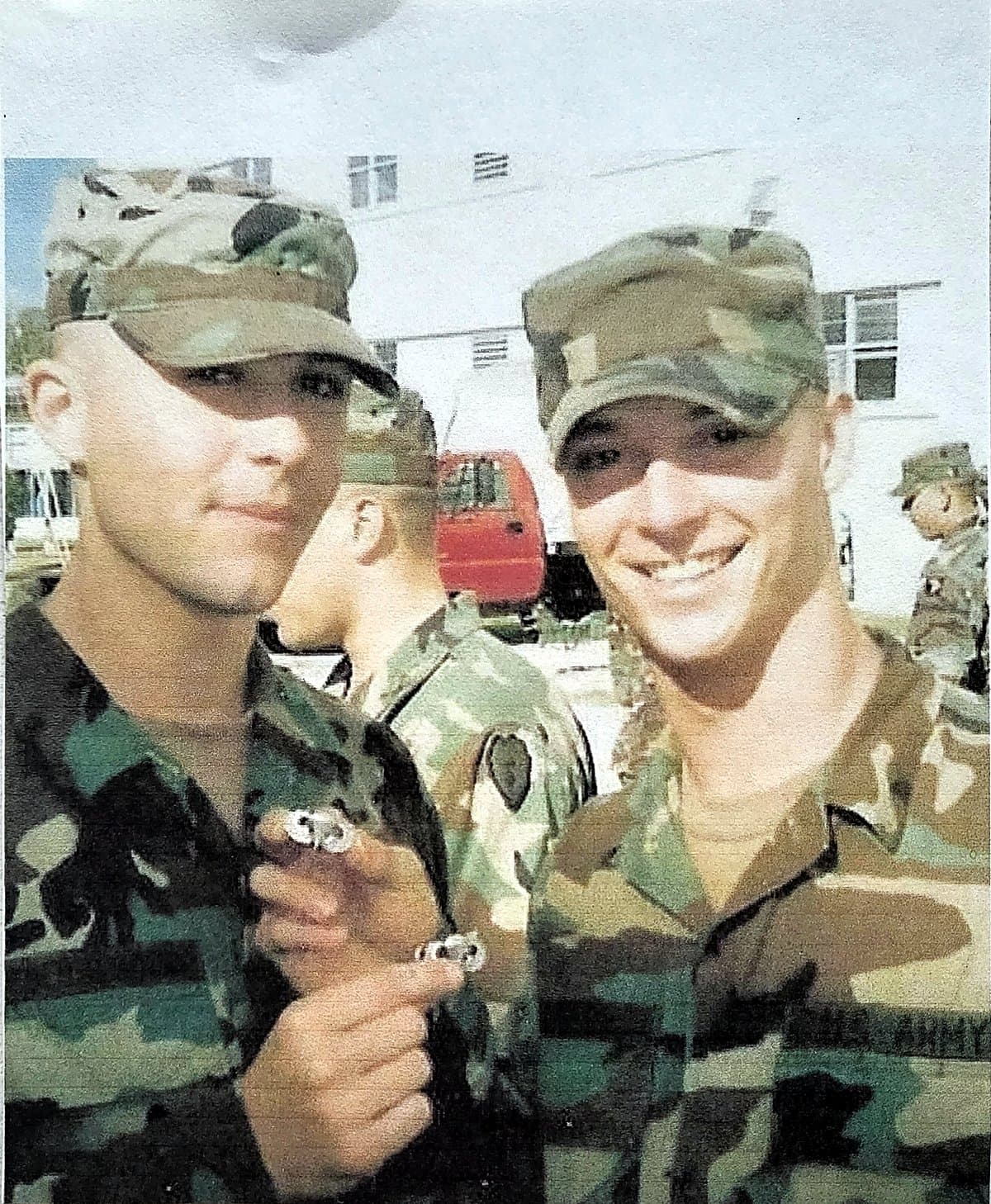A young Bradley Griffin in uniform with a fellow soldier, holding their newly earned parachutist wings at Airborne School